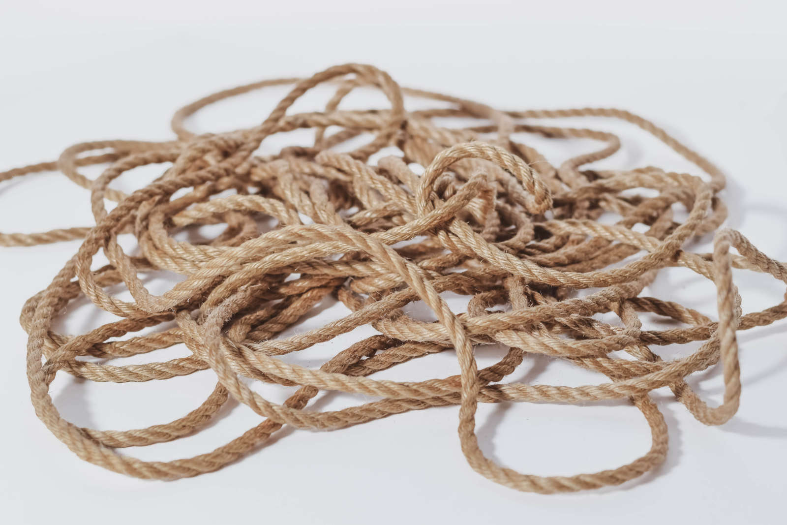 Jute ropes unhanked on a white background